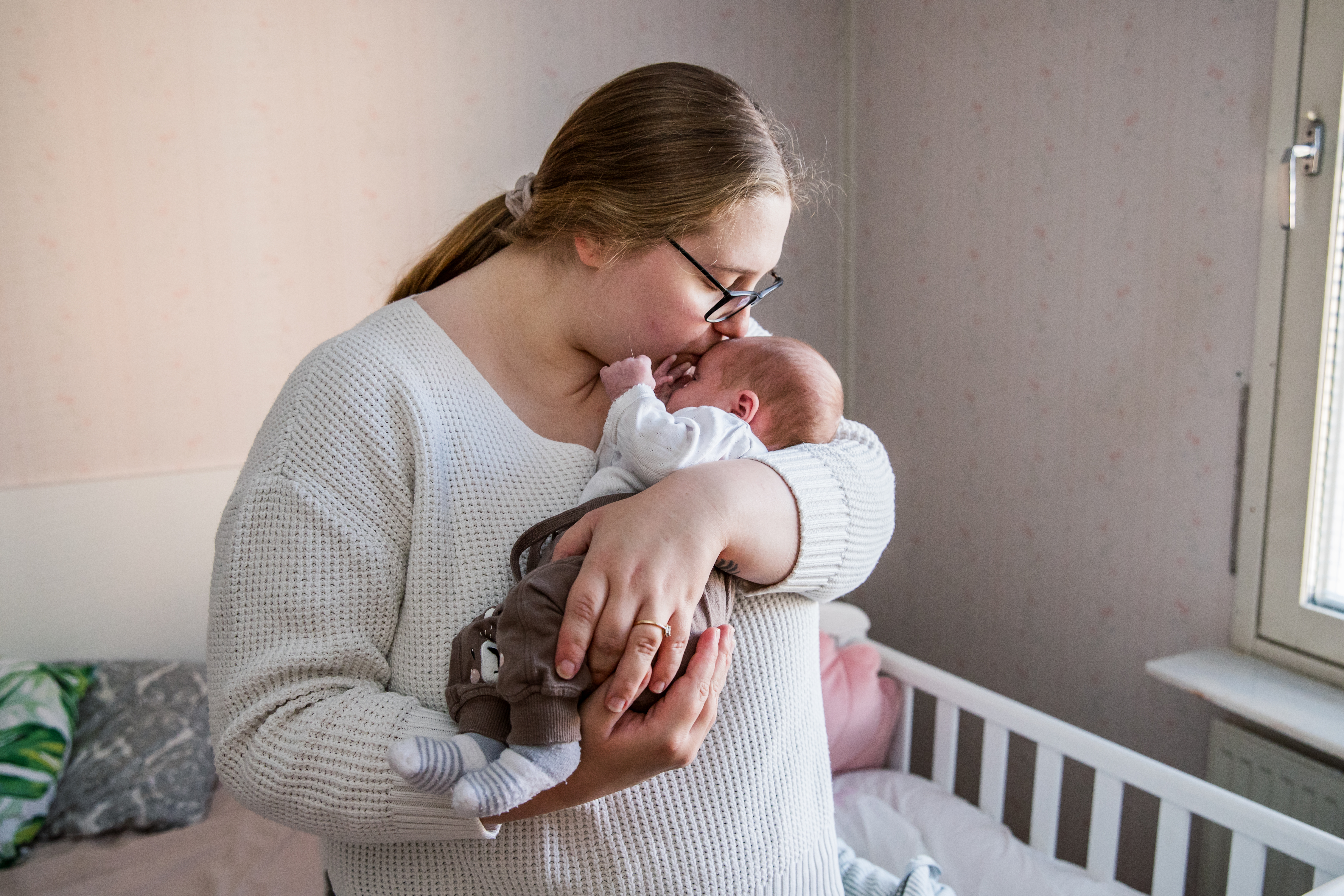 En vuxen person håller ett litet barn.