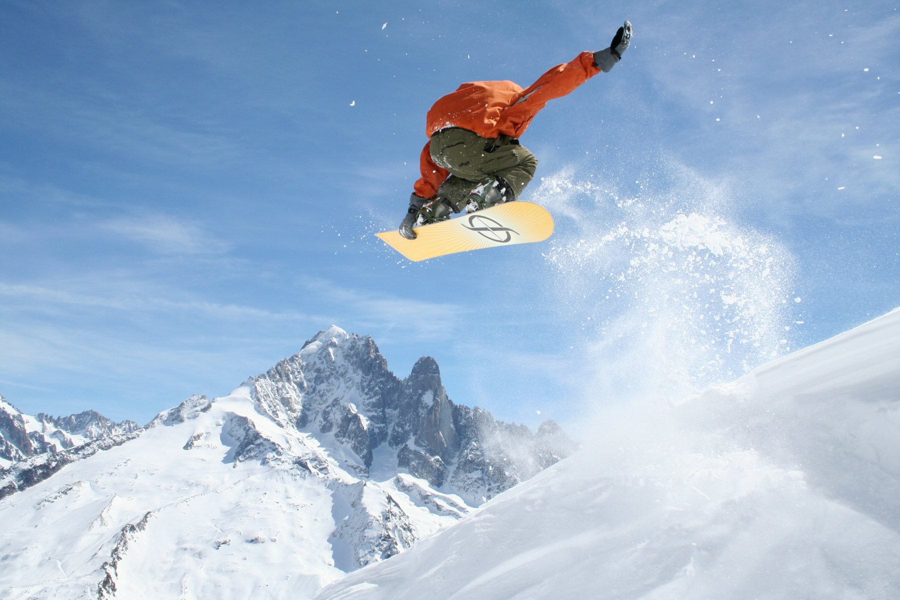 A snowboarder performing a high jump