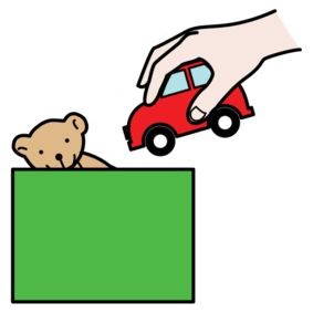 en hand som plockar upp en leksaksbil